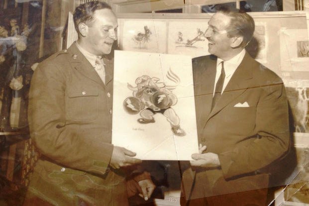 While stationed at Luke Air Force Base in Arizona, Sgt. Seymour Pine had the unique privilege of accepting the 62nd Fighter Squadron emblem of a boxing bulldog from the artist who drew it -- Walt Disney. (Photo courtesy from Richard Pine) While stationed at Luke Air Force Base in Arizona, Sgt. Seymour Pine had the unique privilege of accepting the 62nd Fighter Squadron emblem of a boxing bulldog from the artist who drew it -- Walt Disney. (Photo courtesy from Richard Pine)